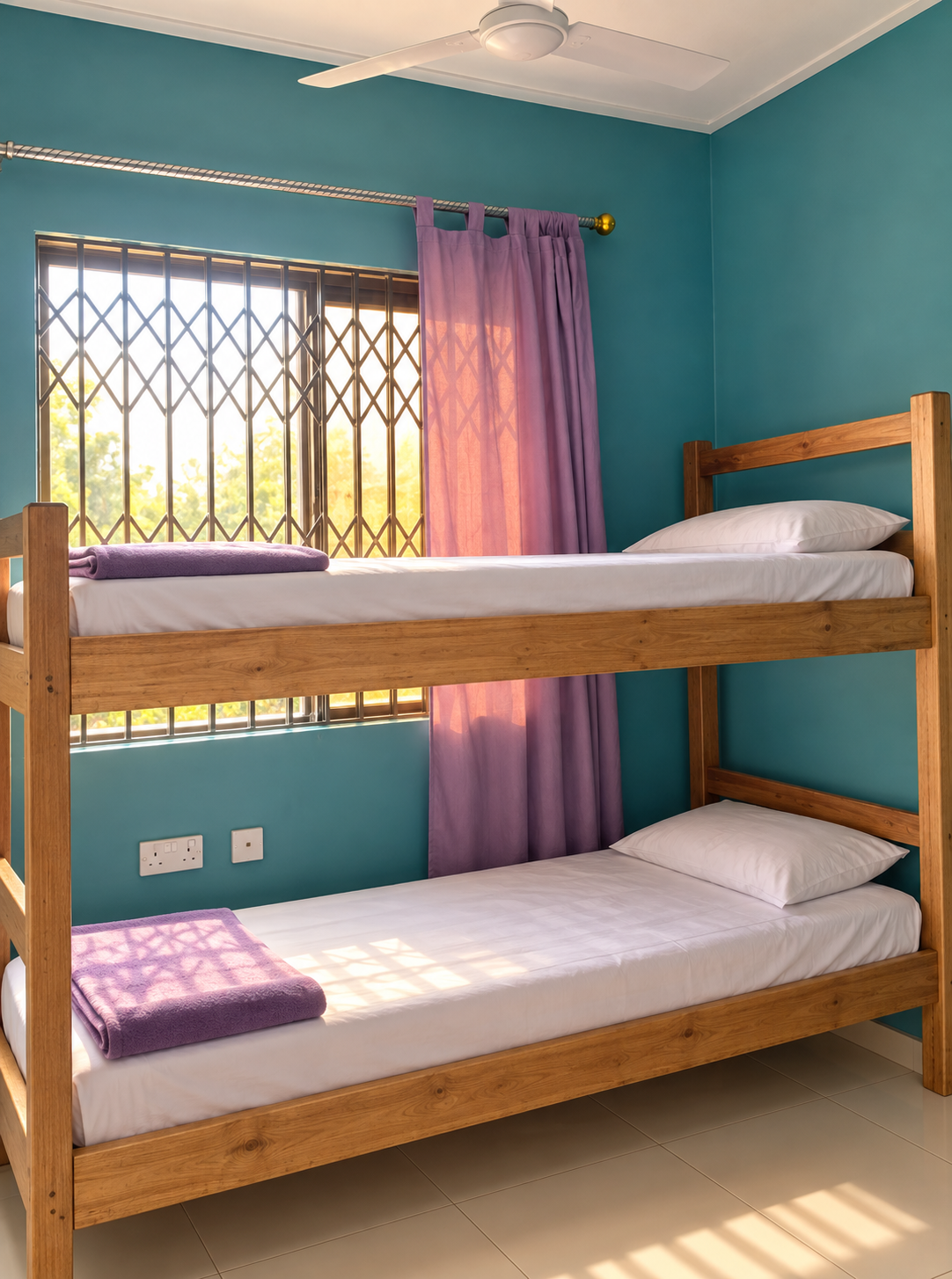 Clean furnished student hostel room with bunk beds and mattresses